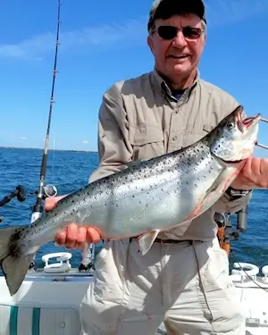 Angler showing off a large Lake Ontario Atlantic salmon.