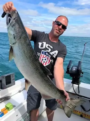 Angler showing off a large Lake Ontario king salmon.
