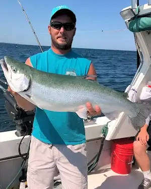 Angler showing off a large Lake Ontario coho salmon.
