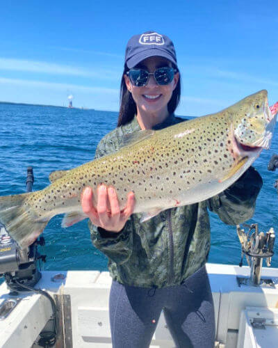 Young lady angler displays nice Lake Ontario early season brown trout.